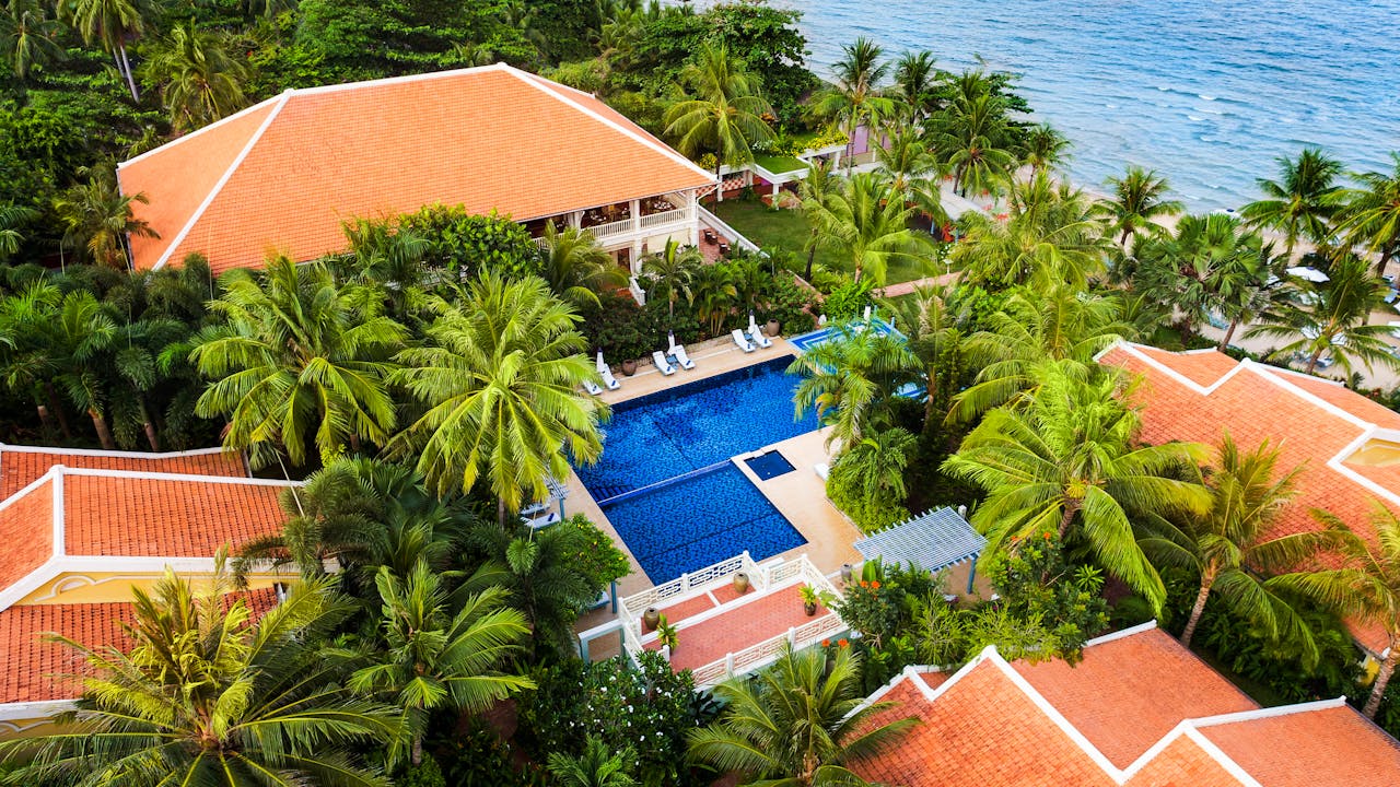 services-bg Aerial view of a luxurious tropical resort with a pool and ocean view in Vietnam.